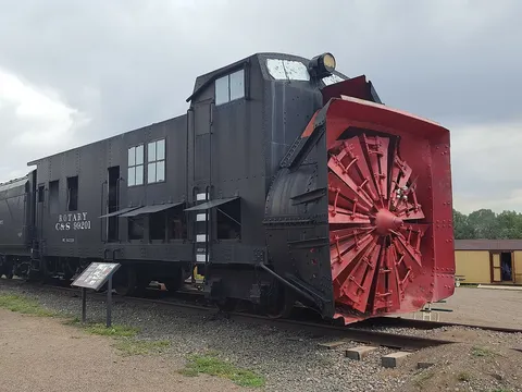Colorado & Southern rotary snowplow 99201, black with a red cutting wheel, standing on a track in the Colorado Railroad Museum yard